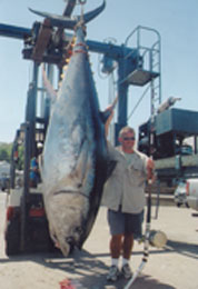 man next to huge tuna