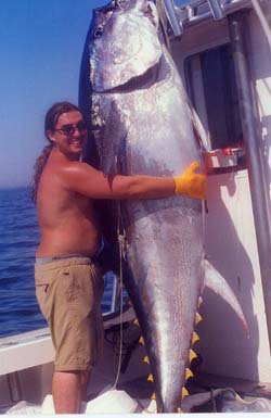 man hugging giant tuna