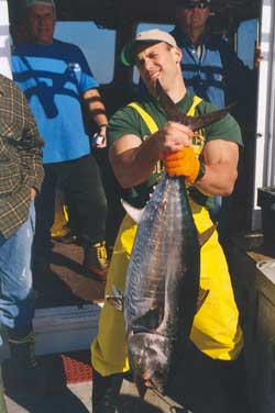 man holding up tuna