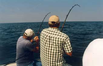 men fishing off boat