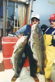 man posing with deep sea fish he caught