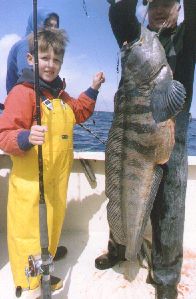 child with deep sea fish he caught