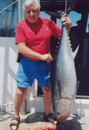man showing off tuna catch